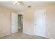 Neutral bedroom featuring a ceiling fan, carpeted floors, and doors leading to other rooms at 1792 Presidio Dr, Clermont, FL 34711