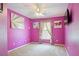 Magenta bedroom featuring a ceiling fan, carpeted floors, and natural light from the window at 1792 Presidio Dr, Clermont, FL 34711