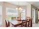 Bright dining area featuring a large table, with views of the backyard through large windows at 1792 Presidio Dr, Clermont, FL 34711