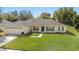 Attractive one-story home featuring a manicured lawn, a two-car garage and a quaint front porch at 1792 Presidio Dr, Clermont, FL 34711