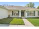 The inviting covered porch is furnished with chairs and sconce lighting for relaxing outdoor living at 1792 Presidio Dr, Clermont, FL 34711