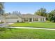 Charming single-story home boasts a well-manicured lawn, attached garage, and inviting front porch, perfect for curb appeal at 1792 Presidio Dr, Clermont, FL 34711