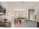 An eat-in kitchen features a stainless steel oven, sink, and a dining table with a view at 1792 Presidio Dr, Clermont, FL 34711