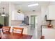 Bright kitchen with white cabinetry, tile floors, and a breakfast bar open to the dining area at 1792 Presidio Dr, Clermont, FL 34711