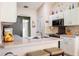 Functional kitchen with white cabinets, stainless steel sink, and convenient breakfast bar seating at 1792 Presidio Dr, Clermont, FL 34711