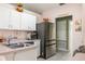 Bright kitchen featuring white cabinets, stainless steel appliances and modern faucet fixtures at 1792 Presidio Dr, Clermont, FL 34711