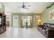 Bright living room featuring tile floors, comfortable seating, and large windows for ample natural light at 1792 Presidio Dr, Clermont, FL 34711