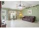 Inviting living room with tile flooring, neutral paint, vaulted ceiling, and large windows for natural light at 1792 Presidio Dr, Clermont, FL 34711