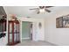 Spacious living room with display case, open doorway and ceiling fan at 1792 Presidio Dr, Clermont, FL 34711