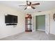 Living room featuring a ceiling fan, display case, and double doors leading to another room at 1792 Presidio Dr, Clermont, FL 34711
