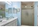 Main bathroom with double sinks, a walk-in shower and blue accent walls at 1792 Presidio Dr, Clermont, FL 34711