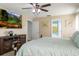 Bright main bedroom featuring a TV, king bed and access to the main bathroom at 1792 Presidio Dr, Clermont, FL 34711