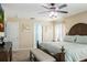Spacious main bedroom featuring a ceiling fan, king bed and access to the main bathroom at 1792 Presidio Dr, Clermont, FL 34711