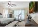 Bright main bedroom featuring a treadmill, television and windows with curtains at 1792 Presidio Dr, Clermont, FL 34711