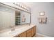The bathroom has a double sink vanity, large mirror and cabinet doors at 181 Sutter Dr, Clermont, FL 34711
