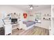 A well lit bedroom that features a desk, shelving, bed and laminate flooring at 181 Sutter Dr, Clermont, FL 34711