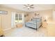 This bedroom features a ceiling fan, window and light wood colored flooring at 181 Sutter Dr, Clermont, FL 34711