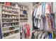 A fully stocked walk in closet with shelving for shoes, purses and clothes at 181 Sutter Dr, Clermont, FL 34711