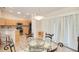Cozy dining area adjacent to the kitchen with a glass-top table and natural lighting at 181 Sutter Dr, Clermont, FL 34711