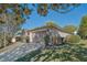 Single-story home features a long drive and a two-car garage with room for storage on the side at 181 Sutter Dr, Clermont, FL 34711