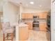 Well-lit kitchen featuring modern stainless steel appliances and barstool seating at peninsula at 181 Sutter Dr, Clermont, FL 34711