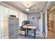 Sunroom converted to office space, featuring a ceiling fan and sliding glass door access at 181 Sutter Dr, Clermont, FL 34711
