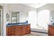 Bright bathroom features a large soaking tub with tile surround and a dual sink vanity at 20755 Queen Alexandra Dr, Leesburg, FL 34748