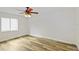 Cozy bedroom featuring a ceiling fan, modern flooring, and a window for natural light at 20755 Queen Alexandra Dr, Leesburg, FL 34748