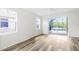 Serene bedroom with wood floors and sliding glass doors leading to the screened lanai and pool at 20755 Queen Alexandra Dr, Leesburg, FL 34748