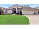 Charming single-story home with a well-manicured lawn and a two-car garage at 20755 Queen Alexandra Dr, Leesburg, FL 34748