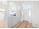 Bright foyer with tile flooring, decorative columns, and arched window above the front door at 20755 Queen Alexandra Dr, Leesburg, FL 34748