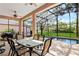 Outdoor lanai with a dining table set, ceiling fans, and a beautiful pool view at 20755 Queen Alexandra Dr, Leesburg, FL 34748