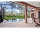 Refreshing pool area featuring a screened-in lanai and lush green backyard at 20755 Queen Alexandra Dr, Leesburg, FL 34748