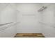 Spacious walk-in closet with wood floor and ample shelving on four walls for optimal storage at 20755 Queen Alexandra Dr, Leesburg, FL 34748