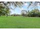 A sprawling green lawn extends towards the horizon at 20755 Queen Alexandra Dr, Leesburg, FL 34748