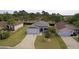 Aerial view of a well-maintained home with a manicured lawn and inviting curb appeal at 2082 Harston Trl, The Villages, FL 32162