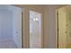 Hallway view showcasing doorways leading to the bathroom and bedroom at 2082 Harston Trl, The Villages, FL 32162