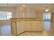 Kitchen with dishwasher and breakfast bar open to a bright living area at 2082 Harston Trl, The Villages, FL 32162