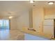 Kitchen with breakfast bar overlooking an adjacent room with a sliding glass door to the screened patio at 2082 Harston Trl, The Villages, FL 32162