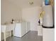 Bright laundry room with washer, dryer, utility sink and hot water heater at 2082 Harston Trl, The Villages, FL 32162