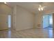 Spacious living room featuring light wood floors, a sliding glass door, and neutral wall paint at 2082 Harston Trl, The Villages, FL 32162
