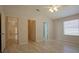 Bright main bedroom featuring wood floors, a ceiling fan, and multiple doorways at 2082 Harston Trl, The Villages, FL 32162