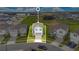 Aerial view of a neatly bordered home with landscaped yard in a suburban neighborhood at 2116 Lelani Cir, Davenport, FL 33897