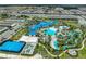 A scenic aerial view showcases the community pool with waterslides, seating areas, a volleyball court, and a lazy river at 2116 Lelani Cir, Davenport, FL 33897