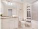 Well-lit bathroom features a granite countertop, modern fixtures, and a shower with gray tiling at 2116 Lelani Cir, Davenport, FL 33897
