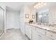 Bright bathroom has a double granite vanity, large mirror, and glass shower enclosure, perfect for daily routines at 2116 Lelani Cir, Davenport, FL 33897