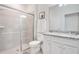 Elegant bathroom with glass-enclosed shower, white cabinets, and granite countertops provides a relaxing retreat at 2116 Lelani Cir, Davenport, FL 33897