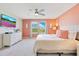 Bright bedroom features a plush bed, modern decor, and natural light, perfect for relaxation at 2116 Lelani Cir, Davenport, FL 33897
