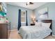 Stylish bedroom features a plush bed, modern decor, and ample natural light from the large window at 2116 Lelani Cir, Davenport, FL 33897