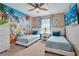 Charming ' bedroom featuring two twin beds, colorful Disney themed mural and fun cartoon decorations at 2116 Lelani Cir, Davenport, FL 33897